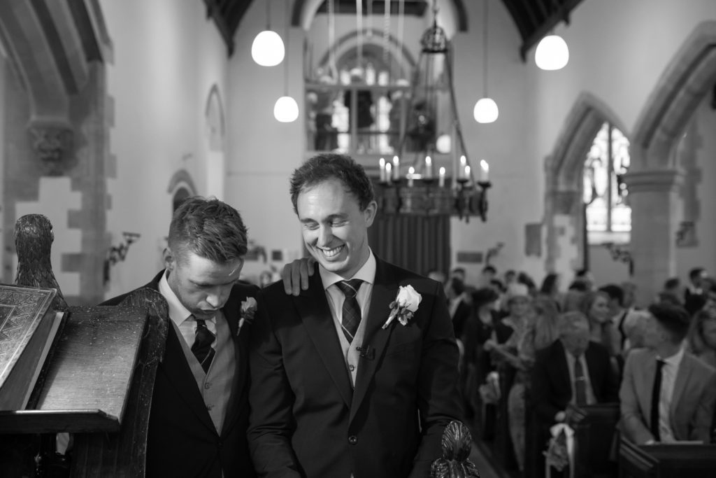 Groom Smiling with Best Man