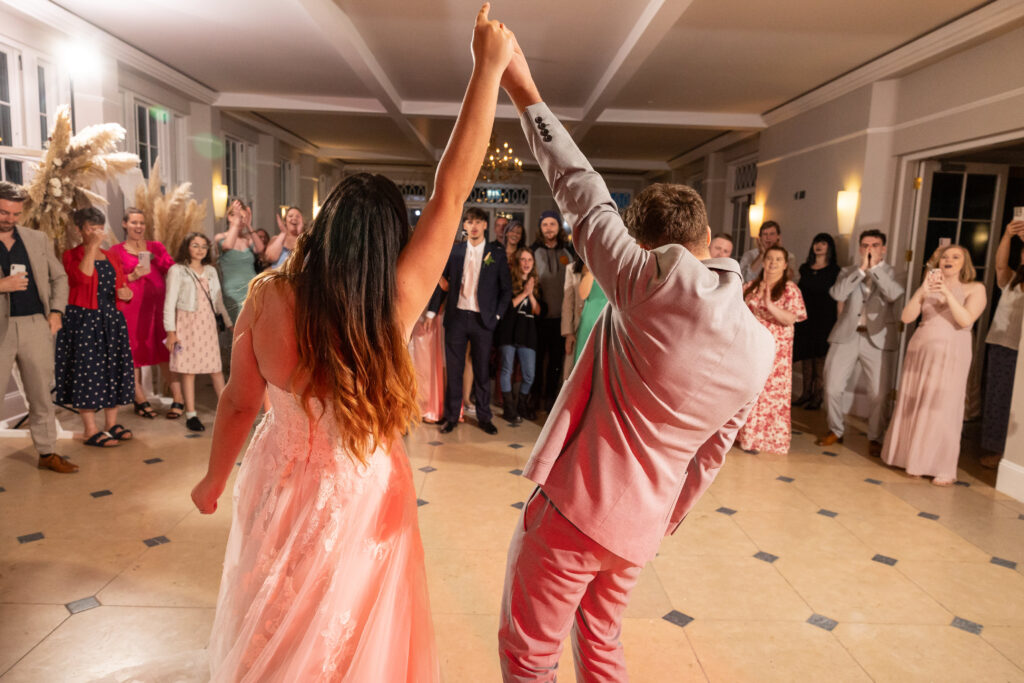 Bride and Groom Holding Hands on Dancefloor