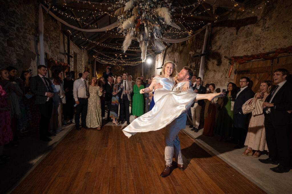 Groom Holding Bride on Dancefloor